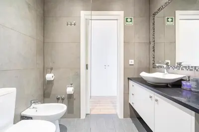 a bathroom with a white toilet and a sink at CASA JOY Vilamoura apartment in Vilamoura