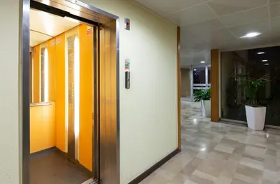 an office hallway with orange and white walls at CASA JOY Vilamoura apartment in Vilamoura