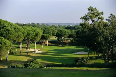 a view of a golf course with trees and a green at CASA JOY Vilamoura apartment in Vilamoura