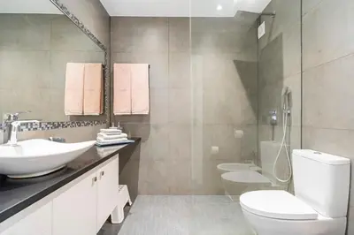 a bathroom with a white toilet and a sink at CASA JOY Vilamoura apartment in Vilamoura