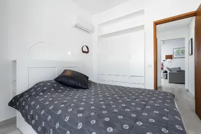 a bedroom with a bed with a black pillow at Casa Mina in Faro