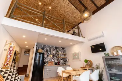 a kitchen and dining room with a table and chairs at FARO DOWNTOWN STUDIOS in Faro