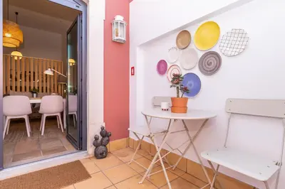 a dining room with a table and plates on the wall at FARO DOWNTOWN STUDIOS in Faro