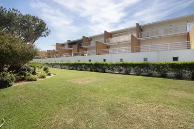 a large building with a lawn in front of it at Yara Beach Apartments with Terrace in Albufeira