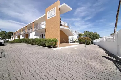 a building with a clock on the side of it at Yara Beach Apartments with Terrace in Albufeira