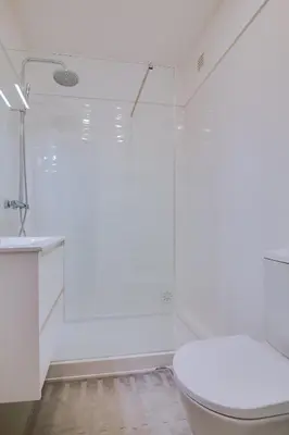 a white bathroom with a toilet and a shower at Ella - Fantastic apartment - Vilamoura in Vilamoura