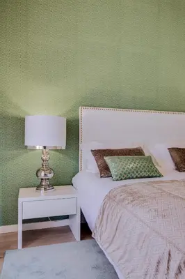 a bedroom with two beds and a table with a lamp at Ella - Fantastic apartment - Vilamoura in Vilamoura