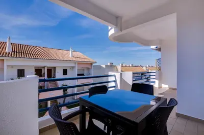 a balcony with a blue table and chairs at Ella - Fantastic apartment - Vilamoura in Vilamoura