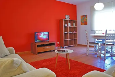 a living room with a tv and a table at Martin House - Montenegro - FARO - ALGARVE in Faro