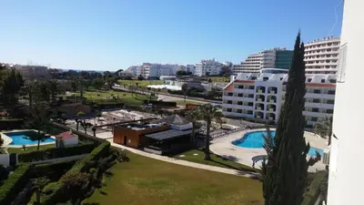 a view of a city with a building and a pool at Rising Sun Apartment in Albufeira