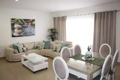a living room with a couch and a table at Rising Sun Apartment in Albufeira