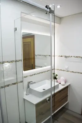 a bathroom with a sink and a mirror at Rising Sun Apartment in Albufeira