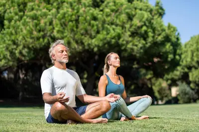 a man and a woman sitting on the grass at EPIC SANA Algarve Hotel in Albufeira