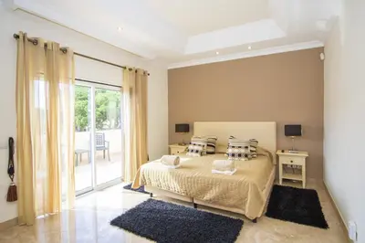 a bathroom with a sink and a tub and a toilet at Villa Hera in Vilamoura