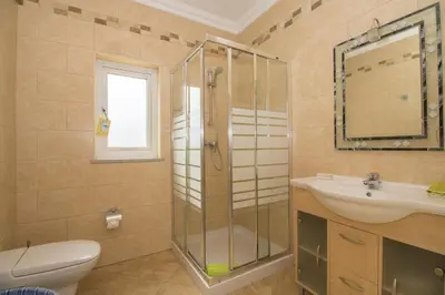 a bathroom with a sink and a toilet and a shower at Villa Hera in Vilamoura