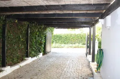 an entrance to a building with an ivy covered wall at Vila 67 in Albufeira
