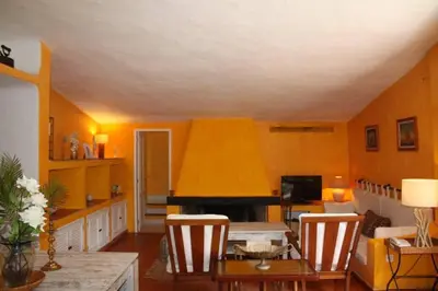 a living room with a table and chairs and a piano at Vila 67 in Albufeira