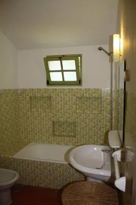 a bathroom with a tub and a sink and a toilet at Vila 67 in Albufeira
