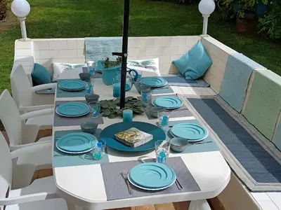 a white table with blue plates on it at Vila 67 in Albufeira