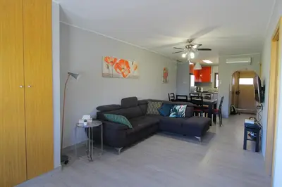 a living room with a couch and a table at Apartamento das Oliveiras in Albufeira