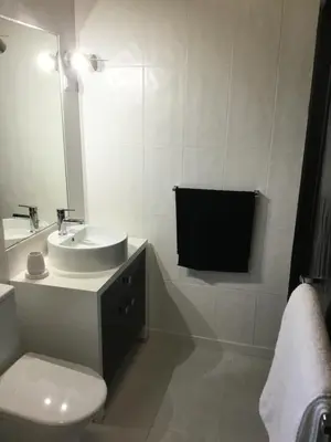 a bathroom with a sink and a toilet and a mirror at Chambre d Hôte exclusif Naturiste et Nudiste CASA AMSYL adultes only in Paderne