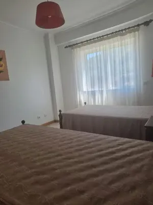 a bedroom with two beds and a window at Albufeira Apart. T2 Baixa in Albufeira