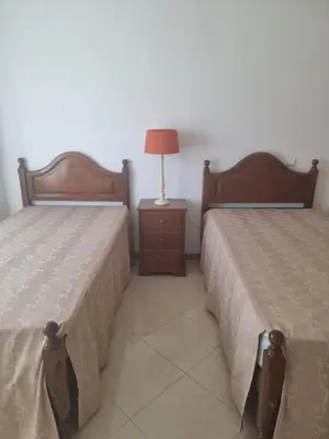 two beds sitting next to each other in a room at Albufeira Apart. T2 Baixa in Albufeira