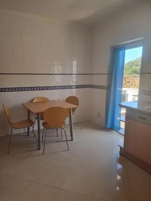 a dining room with a table and chairs and a window at Albufeira Apart. T2 Baixa in Albufeira