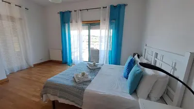 a bedroom with a bed with two babies on it at Albufeira Marina Penthouse 1 in Albufeira