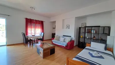 a living room with two beds and a couch and a table at Albufeira Marina Penthouse 1 in Albufeira