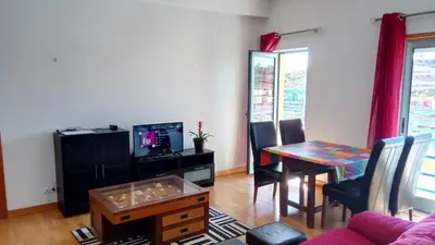 a living room with a table and a dining room at Albufeira Marina Penthouse 1 in Albufeira