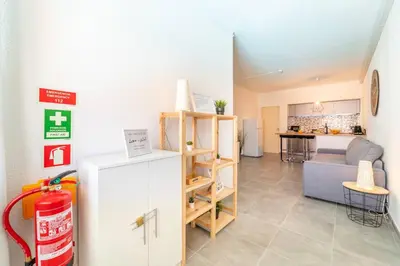 a living room with a refrigerator and a kitchen at Villa Magna - Apt- 206 by HelloVacations in Albufeira
