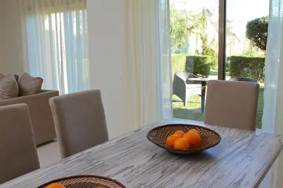 a bowl of oranges sitting on a wooden table at Pinheiros da Balaia Villas in Albufeira