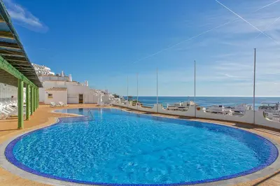a large blue swimming pool on top of a building at AZUL/MAR ALBUFEIRA 602 in Albufeira