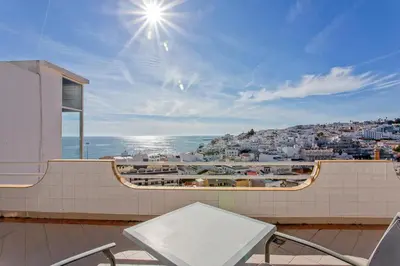 a balcony with a table and a view of a city at AZUL/MAR ALBUFEIRA 602 in Albufeira