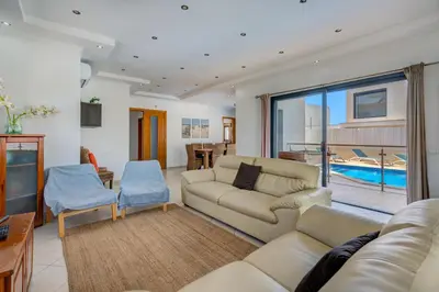 a living room with a couch and a table at Villa Ruana - 5 bedrooms on Suite- Free out door Hot Jacuzzi - By Bedzy in Albufeira