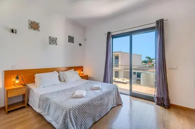 a bedroom with a bed and a large window at Villa Ruana - 5 bedrooms on Suite- Free out door Hot Jacuzzi - By Bedzy in Albufeira