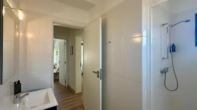 a white bathroom with a shower and a sink at Medronheira by Check-in Portugal in Albufeira