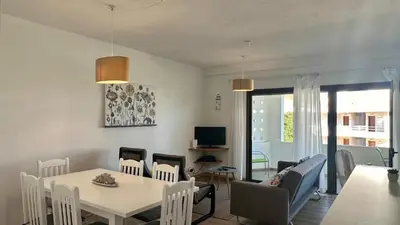 a living room with a dining room table and chairs at Medronheira by Check-in Portugal in Albufeira