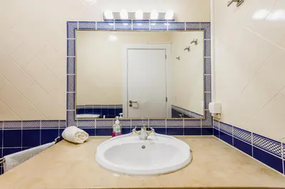 a bathroom with a sink and a large mirror at Aldeia das Açoteias Apartment in Roja- Pé