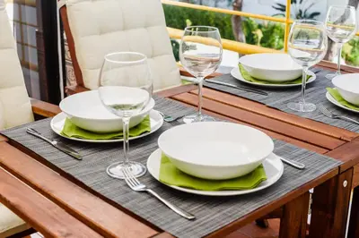 a table with plates and wine glasses on it at Aldeia das Açoteias Apartment in Roja- Pé