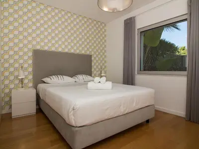 a bedroom with a large white bed with a window at Harmony 4F House - Privat Heated Pool & Privacy & Albufeira in Albufeira