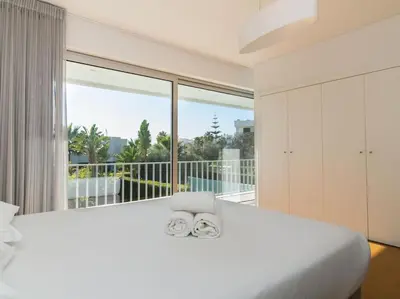 a bedroom with a large white bed and a large window at Harmony 4F House - Privat Heated Pool & Privacy & Albufeira in Albufeira