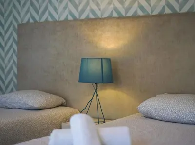 a bedroom with two beds and a blue lamp at Harmony 4F House - Privat Heated Pool & Privacy & Albufeira in Albufeira