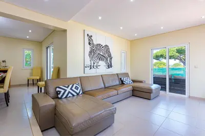 a living room with a couch and a table at Villa Carlivo in Albufeira