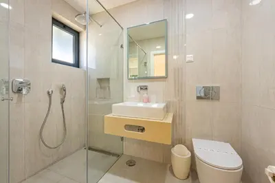 a bathroom with a toilet and a sink and a shower at Villa Casinha in Albufeira