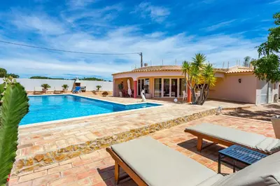 a villa with a swimming pool and a house at Villa Dolce Vita in Albufeira