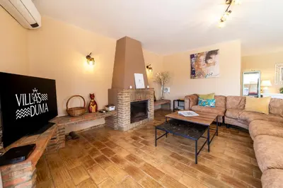 a living room with a couch and a fireplace at Villa Dolce Vita in Albufeira