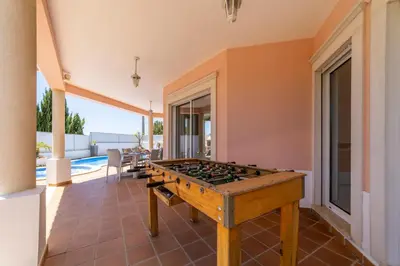 a pool table in the middle of a room at Villa Duma in Albufeira
