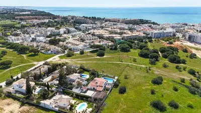an aerial view of a city with houses and the ocean at Villa Maria in Albufeira
